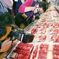 Photographers focus on U.S. beef Wednesday at a store of Costco Japan, the Japanese unit of the U.S. retailer, in Chiba. | AP PHOTO