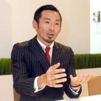 Dai Tamesue, bronze medalist in the man\'s 400-meter hurdies at the World Championships in 2001 and 2005, speaks about investment and hurdling at his management company, Sunny Side Up Inc., in Tokyo on Dec. 11. | YOSHIAKI MIURA PHOTO