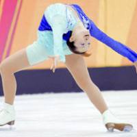 Olympic gold medalist Shizuka Arakawa performs the maneuver called the Ina Bauer during the Winter Games in Turin, Italy, in February 2006. | KYODO PHOTO
