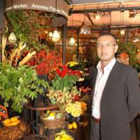 Hideaki Inoue, president of Park Corp., stands in front of an Aoyama Flower Market shop in Minato Ward, Tokyo, earlier this month. | SATOKO KAWASAKI PHOTO