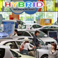 Visitors examine cars at the Toyota Mega Wave showroom in Tokyo last month. | AP PHOTO