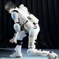 A man demonstrates the robotic suit HAL, which assists disabled people to move their limbs. | CYBERDYNE INC. PHOTO/KYODO