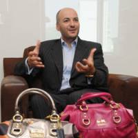 Fashion sense: Displaying the latest handbags in the Madison Collection that will hit the market later this month, Coach Japan Inc. President Victor Luis gives an interview at his company\'s head office in Tokyo last week. | SATOKO KAWASAKI PHOTO
