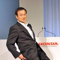 Not so easy rider: Honda Motor Co. President Takanobu Ito tests the U3-X electric unicycle at a news conference in Tokyo on Thursday. | YOSHIAKI MIURA PHOTO