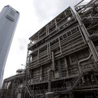 Thermal juice: Tokyo Electric Power Co.\'s Shinagawa thermal power station in Tokyo includes a heat recovery steam generator and chimney tower. | BLOOMBERG