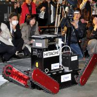 On track: The Tsubaki robot, developed by a startup firm of Chiba Institute of Technology, goes through its motions Wednesday in Narashino, Chiba Prefecture. | YOSHIAKI MIURA