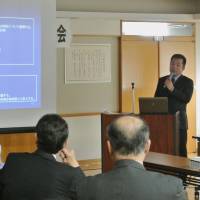 Power plug: An official from trading house Marubeni Corp. briefs local officials about plans to start geothermal power generation Tuesday in the town of Kamikawa, Hokkaido. | KYODO