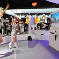 Game face: Research engineer Mikael Le Goff checks out Sony\'s PlayStation Vita at Tokyo Game Show on Thursday. Japan\'s largest video-game event continues through Sunday, and will be open to the public on Sept. 17-18. | YOSHIAKI MIURA PHOTO