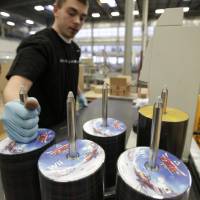 Best seller: Stacks of “Legend of Zelda: Skyward Sword” game-disks for the Nintendo Wii being fed into a packaging machine at the Nintendo of America Inc. distribution center in North Bend, Washington, Nov. 16, 2011. Nintendo makes it through rough seas with flagship titles