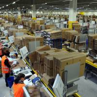 Automatons: Workers at Amazon logistic centers such as this one in in Bad Hersfeld, Germany, see little of the profits made by the online retailing giant. | AFP-JIJI