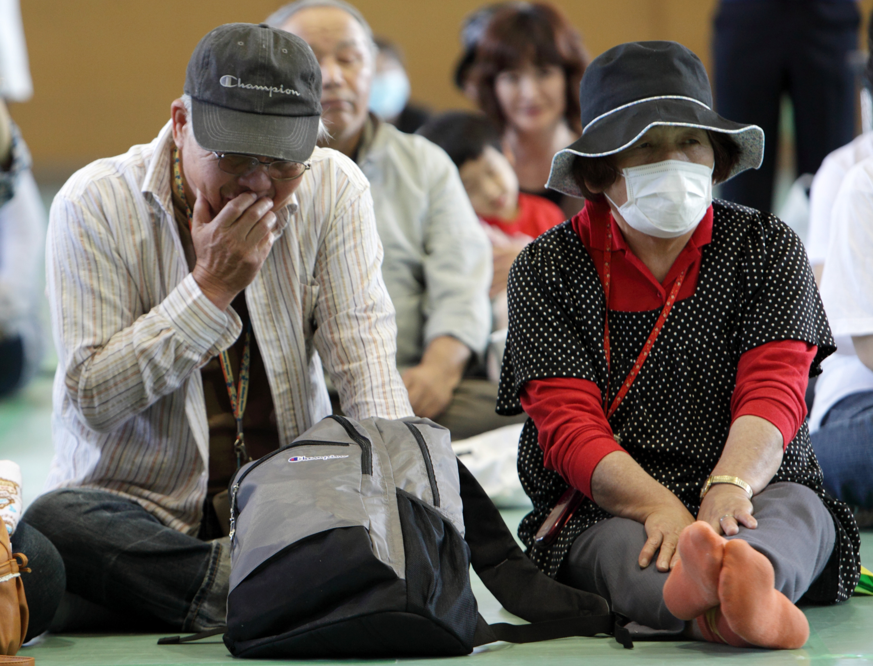 Just the beginning: Evacuees from the 20-km exclusion zone around Tokyo Electric Power Co.'s Fukushima No. 1 nuclear power station attend an event marking three months since the March 11 earthquake and tsunami, in Minamisoma, Fukushima Prefecture, on June 11, 2011. | BLOOMBERG