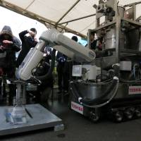 Blaster-master: A Toshiba Corp. prototype remote-controlled decontamination robot blasts dry ice to show how it would peel off radioactive materials, and then later vacuum them up, at the firm\'s Yokohama complex Friday. | KAZUAKI NAGATA
