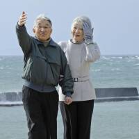 Royal promenade: Emperor Akihito and Empress Michiko take a walk on the seashore near the Imperial villa in Hayama, Kanagawa Prefecture, on Feb. 7. | KYODO