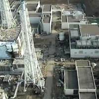 Stricken: An image taken by a T-Hawk drone aircraft in April 2011 and released by Tokyo Electric Power Co. shows the damaged building (left) that houses reactor 4 at the Fukushima No. 1 nuclear plant. | AP