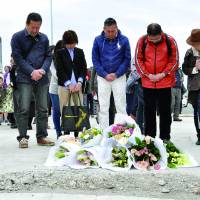 Still Mourning their lossRelatives of Japanese who died when the CTV Building in Christchurch, New Zealand, collapsed in an earthquake in 2011 pray Friday on the anniversary of the tragedy at the site where the structure once stood. | KYODO