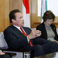 Energizer: Actor and former California Gov. Arnold Schwarzenegger gestures Friday while discussing global warming and energy issues with Environment Minister Nobuteru Ishihara at the latter\'s office. | KYODO