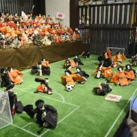 Visitors in Gujo, Gifu Prefecture, view a display of traditional Hina dolls playing soccer &#8212; part of an exhibition that kicked off Feb. 9 in hopes of breathing new life into the annual March 3 doll festival.  | KYODO PHOTO