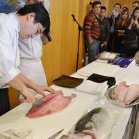 Beyong lox: A representative of Hiroshima-based seafood firm Rumi Japan slices a yellowtail Tuesday at a tasting event for food industry officials at the official residence of the Japanese ambassador to Israel.  | KYODO PHOTO