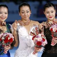 Clean sweep: (from left) Silver-medalist Akiko Suzuki, winner Mao Asada and bronze-medalist Kanako Murakami show their prizes at the Four Continents Figure Skating Championships in Osaka on Sunday. | AP