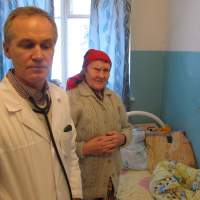 The doctor is in: Dr. Sergei Vishnyakov stands with 72-year-old patient Alexandra Tikhomirova at his hospital in Itomlya, Russia. | THE WASHINGTON POST