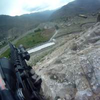 Not a video game: This screen grab from video captured by army Pfc. Ted Daniels\' helmet camera shows a shell casing being discharged from his weapon as he returns fire during an April 2012 firefight on a hillside in Afghanistan. | THE WASHINGTON POST