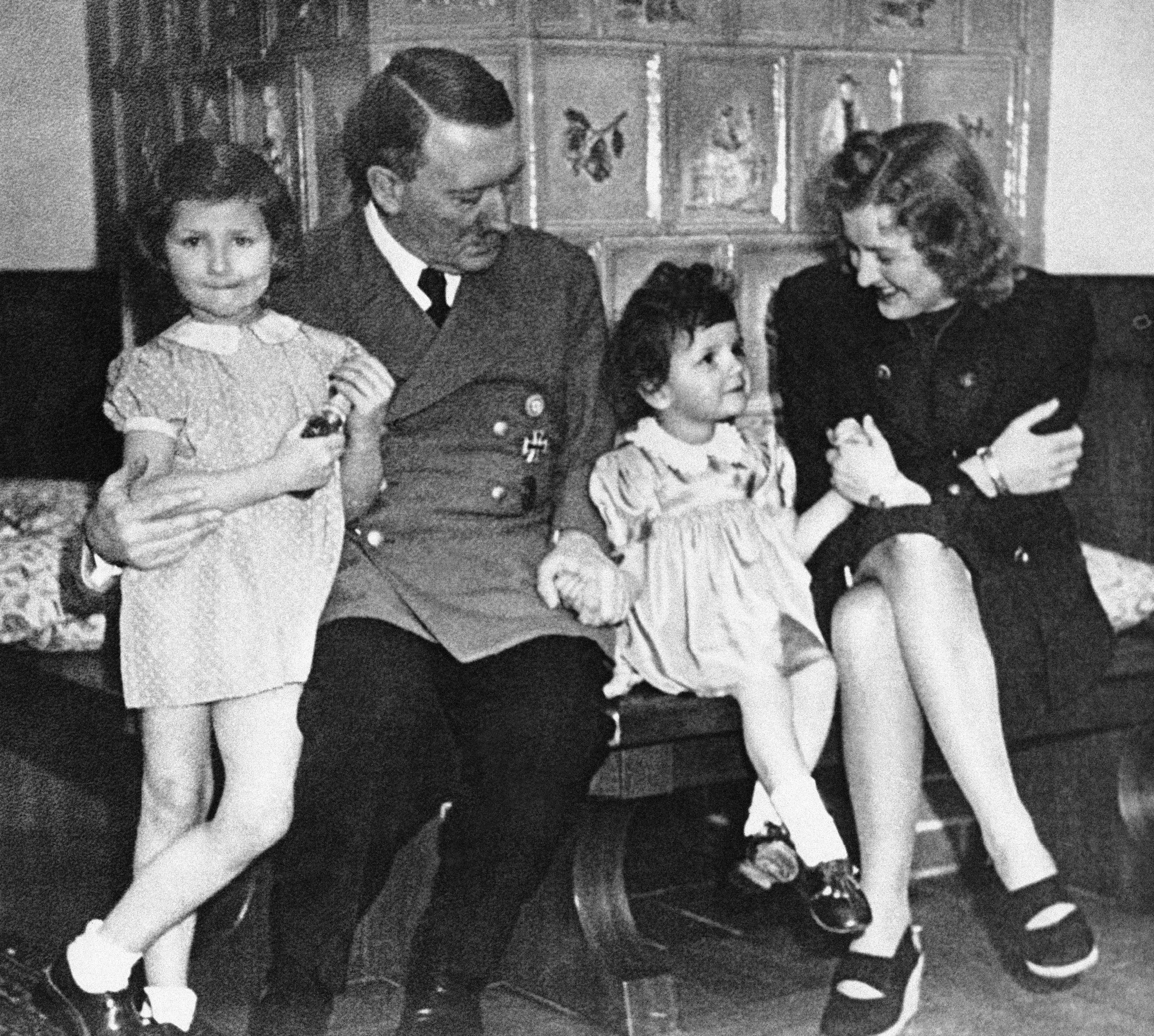Family time: An undated photo of German Chancellor Adolf Hitler, his mistress Eva Braun and two girls were among the many items found in 1945 in a treasure chest belonging to Braun that give an intimate glimpse of the Nazi leader's private life. | AP