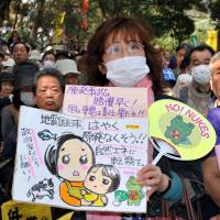 Long goodbye: Antinuclear protesters rally outside the Diet building Sunday in Tokyo, on the eve of the second anniversary of the March 11, 2011, quake and tsunami that triggered one of the worst nuclear catastrophes the world has seen.
 | YOSHIAKI MIURA