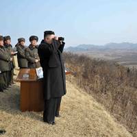 Looking at things: North Korean leader Kim Jong Un (right) inspects an artillery drill. The recent nuclear test by the country has Japan and the world on edge. | AFP-JIJI