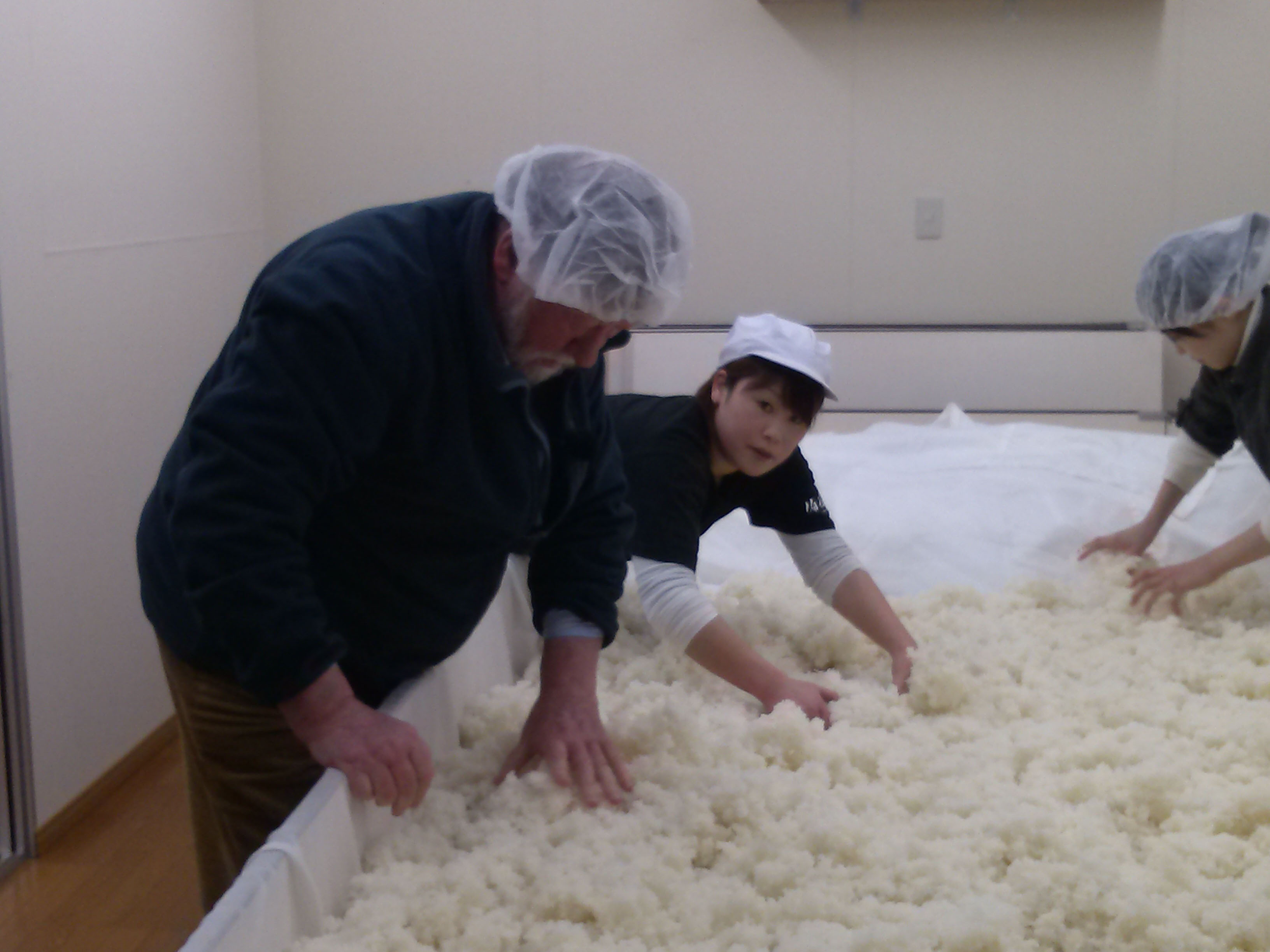 Hands-on: Old Nic helps ferment rice on a visit to fifth-generation sake maker Iwao Niizawa. | TAKUMI TOCHIZAWA