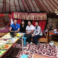 Local feast: Midori Paxton (in black) with a UNDP colleague, project staff and a local community member in a ger, or yurt, in Mongolia. | MIDORI PAXTON