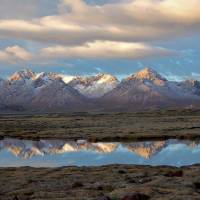 Mirror image: Vistas of majestic mountains, crystal clear lakes and broad wetlands greet visitors to the plateau of Qinghai Province. | MARC FOGGIN.