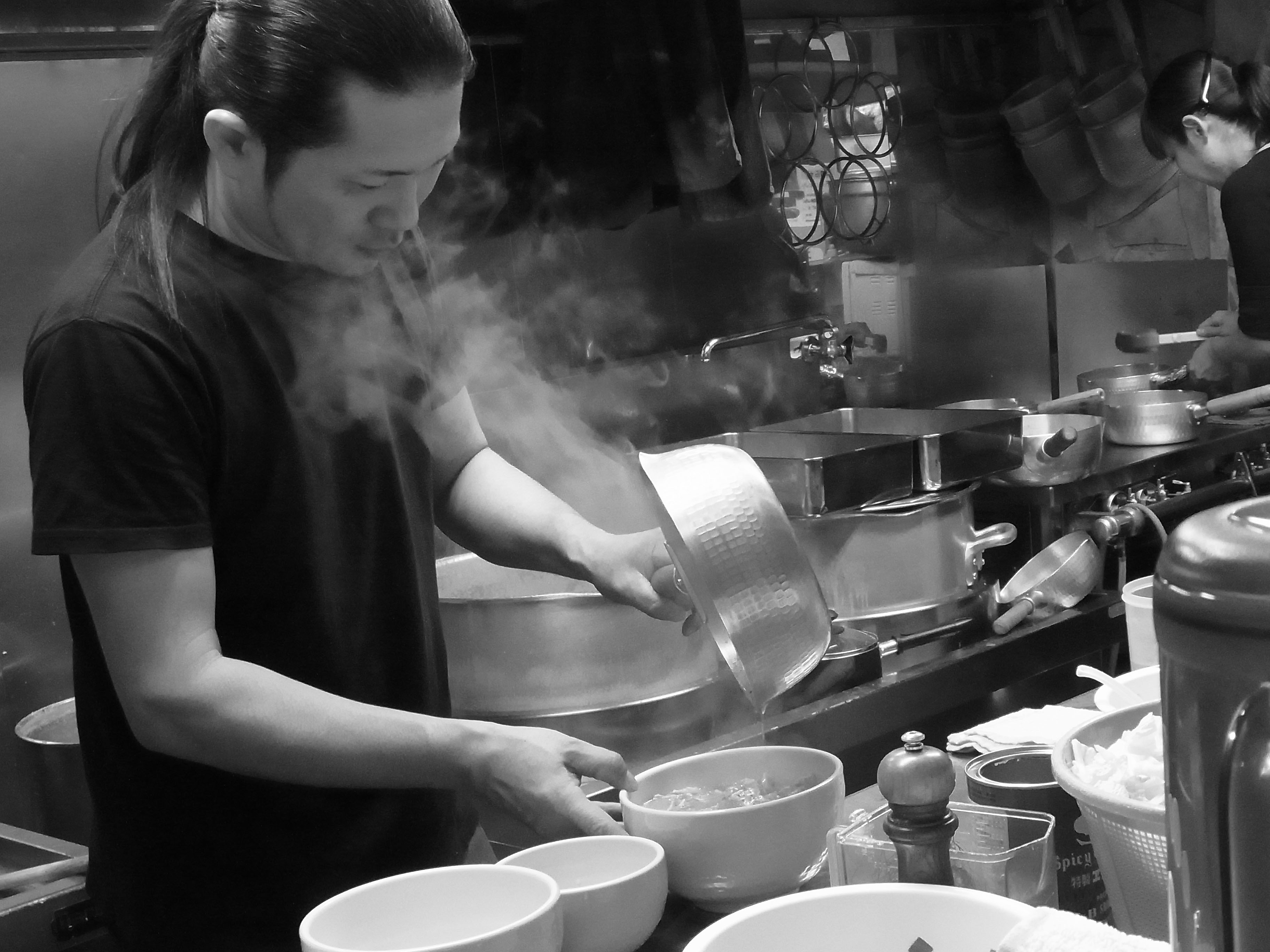 Chef Tsukasa Hasunuma creates a bowl of ramen at his restaurant Gamushara in Hatagaya, Shibuya. | HIROSHI SHIMAKAGE