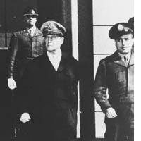 Glancing toward the Imperial Palace, Gen. Douglas MacArthur emerges from the Dai-Ichi Mutual Life Insurance Building in Tokyo. | PHOTO COURTESY OF DUSKIN SERVICEMASTER CO.