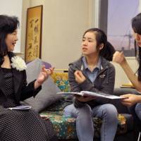 Keiko Hangui shares her story with ASIJ students Risa Endo and Ellie Nishikawa-Fu. | ELLISON STANLEY