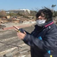 Hearing aid: Nobuko Kikuchi, a deaf resident in the city of Iwanuma, Miyagi Prefecture, shows where her house used to be before it was uprooted and washed away by the monster tsunami on March 11, 2011. | &#169; STUDIO AYA