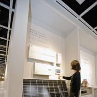 \"Green\" with envy: An employee uses a monitor showing energy usage, savings and other readouts from electrical devices in Panasonic Corp.\'s showroom in Tokyo on Wednesday. | BLOOMBERG PHOTO
