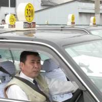 Short and cheap: Shin-Kanaoka Kotsu Co. taxis, charging &#165;320 for the first kilometer, wait for customers Monday in Sakai, Osaka Prefecture. | KYODO PHOTO