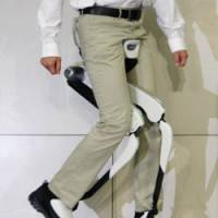Feat of engineering: A man demonstrates a Honda Motor Co. device to aid walking at the firm\'s headquarters in Minato Ward, Tokyo, in November 2008. | KYODO PHOTO