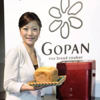 Against the grain: A woman holds a loaf of rice bread Tuesday made by Sanyo Electric Co.\'s Gopan machine at a Tokyo hotel. | KYODO PHOTO