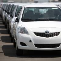 Outbound: Toyota Yaris compacts for export sit in lines at Sendai port on July 14. | BLOOMBERG PHOTO