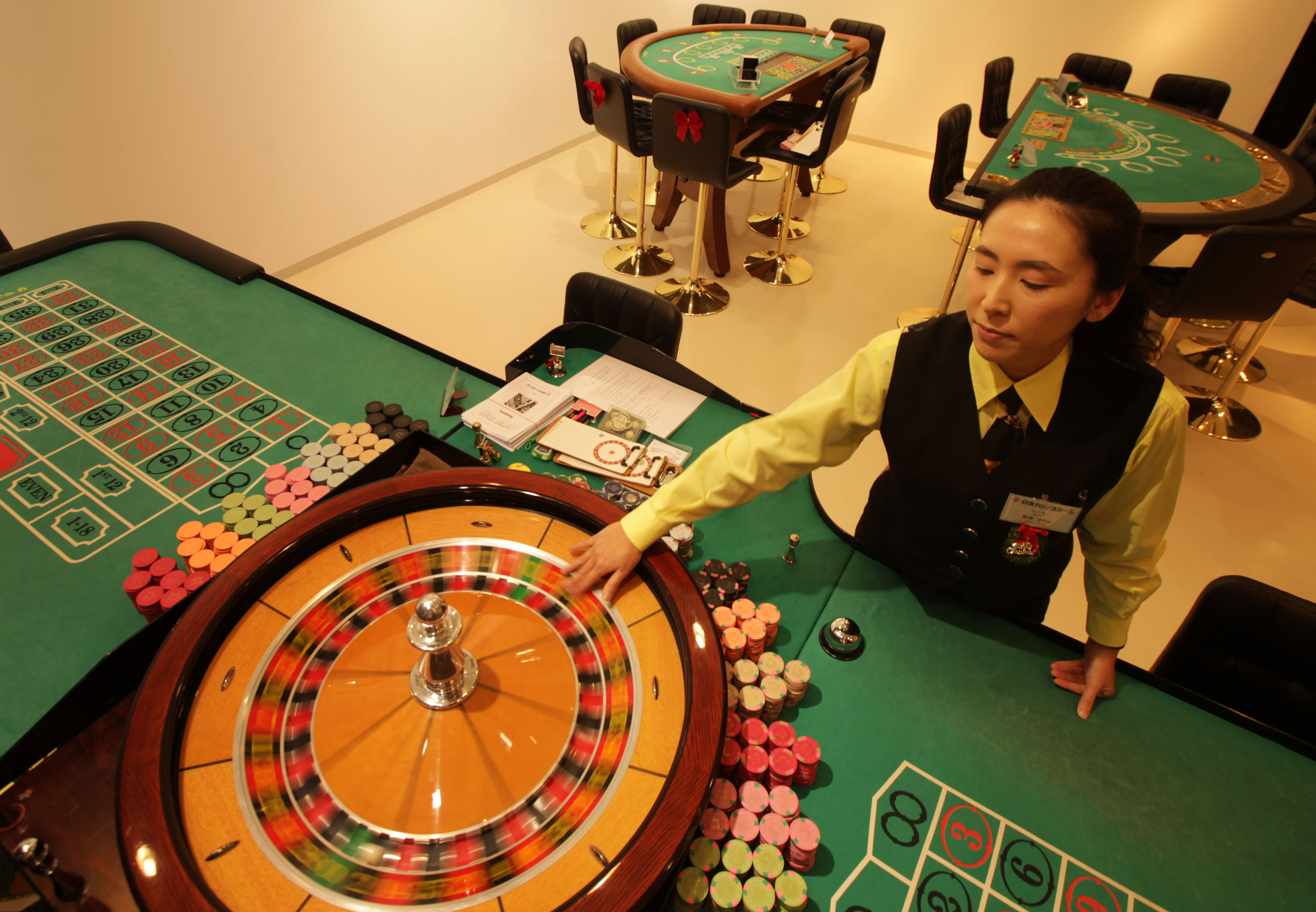 Wheel of fortune: A croupier warms up a roulette wheel at Casino Venus, a mock casino operated by Japan Casino School and Bright Inc. to teach people how to be dealers, in Tokyo on Wednesday. | BLOOMBERG PHOTO
