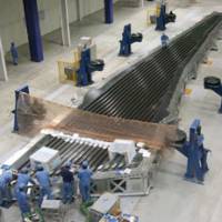 Preflight prep: Workers use Toray Industries Inc.\'s carbon fiber on a main wing section of a Boeing 787 jetliner at Mitsubishi Heavy Industries Ltd.\'s plant in Aichi Prefecture in 2007. | BLOOMBERG
