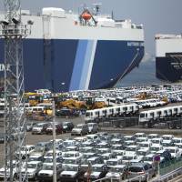 Outward bound:  Vehicles wait to be loaded onto Nippon  Yusen vessels in  Yokohama last week. | BLOOMBERG