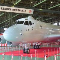 In the hunt: Kawasaki Heavy Industries Ltd.\'s P-1 next-generation antisubmarine patrol aircraft is unveiled at its plant in Gifu Prefecture on Tuesday. The new aircraft will be used by the Maritime Self-Defense Force. | KYODO