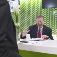 Currency imbalance: Ford Motor Co. President and CEO Alan Mulally prepares for a television interview at the Bloomberg office in Bangkok on Tuesday. | BLOOMBERG
