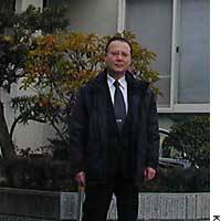 Yoshio Matsushita stands in front of his suburban Tokyo home, the loans for which he managed to repay with his retirement allowances. | PHOTO COURTESY OF YOSHIMI WATANABE