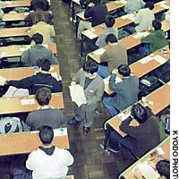 Supervisors distribute  tests Saturday to applicants taking preliminary university examinations at the University of Tokyo. | PHOTO COURTESY OF FORUM YOKOHAMA