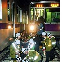 Tokyo subway workers attend to simulated injuries along the train tracks during an earthquake and fire drill on the Hanzomon Line. | KYODO PHOTO, COPYRIGHT 2001 NIBARIKI-TGNDDTM