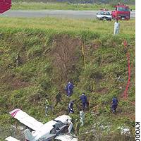 Officials inspect a single-engine plane after it crashed at an airport in Mitsushima, in the Tsushima islands in Nagasaki Prefecture. | PHOTOS FROM THE NATIONAL RESEARCH INSTITUTE FOR CULTURAL PROPERTIES>