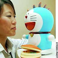 A Bandai Co. employee chats with Doraemon the Robot. | PHOTO COURTESY OF THE SPORTS MEDICAL SCIENCE INSTITUTE